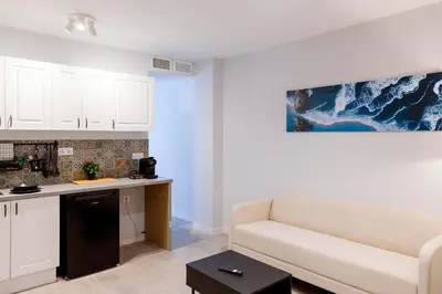 a living room with a couch and a kitchen at Mediterraneo Stay in Valencia
