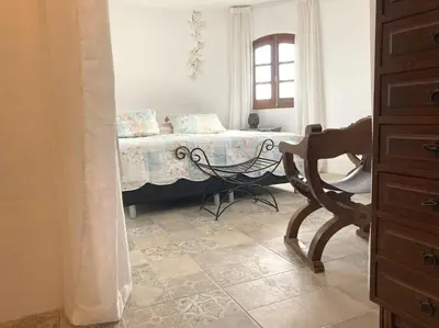a bedroom with a bed and a chair in it at Villa Torre, Valencia Spanje in Macastre