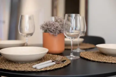 a table with plates and wine glasses on it at Lovely Exclusivity in Valencia Center in Valencia