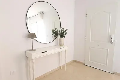 a dressing table with a mirror and a lamp on it at Maravilloso adosado para 8 en entorno privilegiado by Hometels in Canet de Berenguer