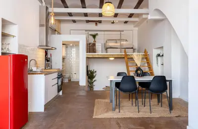 a kitchen and dining room with a table and chairs at Loft Industrial Doble Altura in Valencia