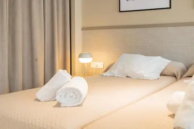 a hotel room with a bed with towels on it at Apartamentos 87 Llaves in Valencia