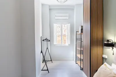 a bedroom with a room with a mirror and a ladder at at Maestro Gozalbo, Ruzafa in Valencia