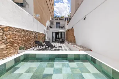 an indoor pool in a building with a stone wall at My Loft 4 You Patraix Style in Valencia