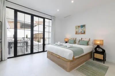 a bedroom with a bed and a large window at My Loft 4 You Patraix Style in Valencia