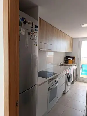 a kitchen with a stainless steel refrigerator and a dishwasher at Beach,s House in Playa del Puig in La Torre