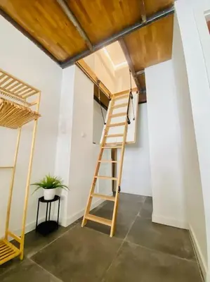 a room with a ladder next to a wall at Beach Flat for Family & Groups in Valencia