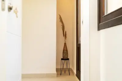a vase sitting on a stool in a hallway at Masia de Matuta in Vall de Almonacid