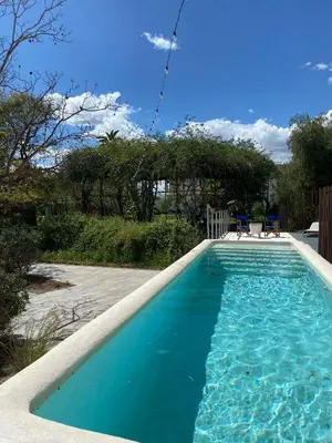 a swimming pool with blue water in a yard at Loft en molino rehabilitado in Paterna