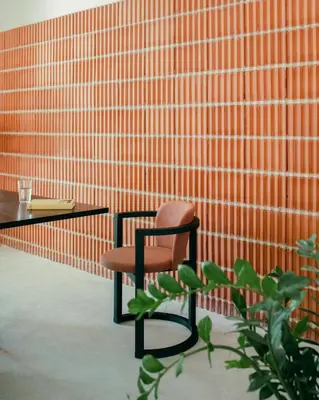 a chair sitting next to a table with a plant at La Casa del Mar in Valencia