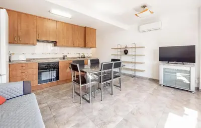 a kitchen with a table and chairs in a room at 2 Bedroom Amazing Apartment In Moncofa in Moncófar