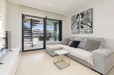 a living room with a couch and a table at ApartUP Patacona Sunrise Duplex II in Valencia
