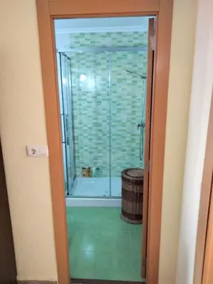 a bathroom with a shower and a tub and a glass door at Acogedor Apartamento Cullera 200 metros playa in Cullera
