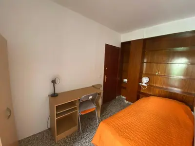 a bedroom with a desk and a bed and a desk and a chair at Family flat zona Aragon close to city center and beach in Valencia