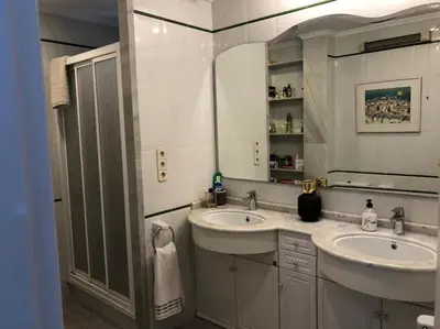 a bathroom with two sinks and a mirror at A modern House with Perfect Views in Mareny Blau