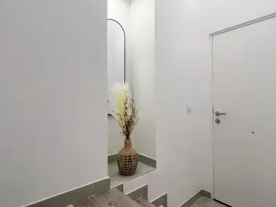 a hallway with a mirror and a vase at Encantador apartamento vigas de madera in Valencia