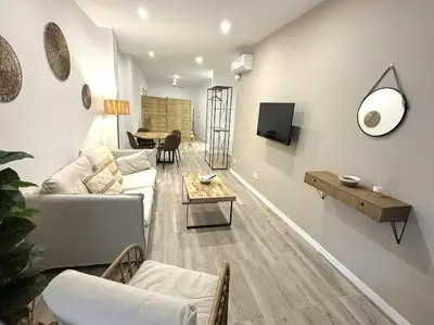 a living room with a couch and a table at Precioso apartamento en la playa in Valencia