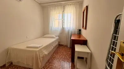 a small bedroom with a bed and a window at Vacaciones en el mar in Puerto de Sagunto