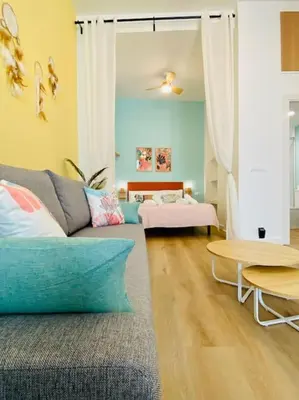 a living room with a couch and a table at Beautiful and Charming Loft in Russafa SOHO in Valencia