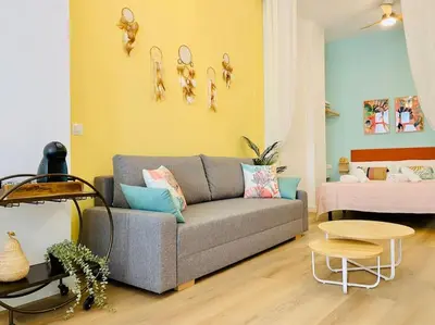 a living room with a couch and a bed at Beautiful and Charming Loft in Russafa SOHO in Valencia