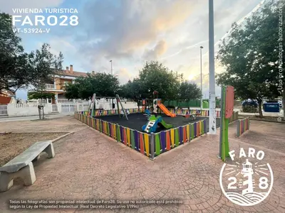 a playground in a park with a bench at Faro28 in Valencia