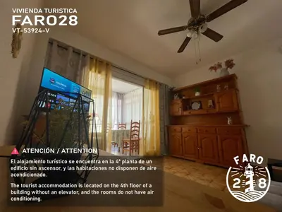 a living room with a ceiling fan and a dresser at Faro28 in Valencia