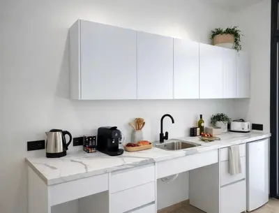a white kitchen with white cabinets and a sink at Avakian Valencia Centro in Valencia