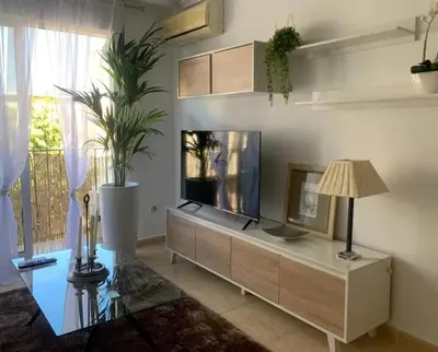 a living room with a fish tank on a cabinet at El balcón de Alexia, 5 minutos del aeropuerto in Partida de La Cañada