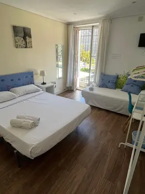 a bedroom with two beds and a window at El Parterre Apartamento in Valencia