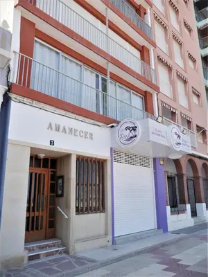 a building with a sign that reads amherger at Amanecer, 1-2 in Cullera