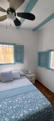 a bedroom with a bed and a ceiling fan at Ca la Yaya in Lliria