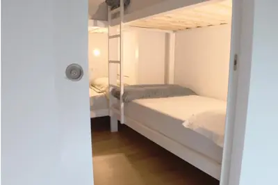 a bedroom with two bunk beds and a door open at Aiora Hostel in Valencia
