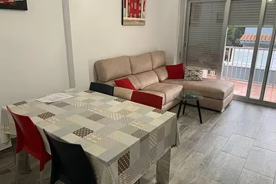 a living room with a couch and a table at Apartamento para 5 personas en Faro de Cullera in Faro de Cullera