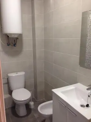 a bathroom with a white toilet and a sink at Apartamento para 5 personas en Faro de Cullera in Faro de Cullera