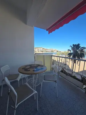 a bathroom with a sink and a toilet and a mirror at Beach view apartment in Cullera in Cullera