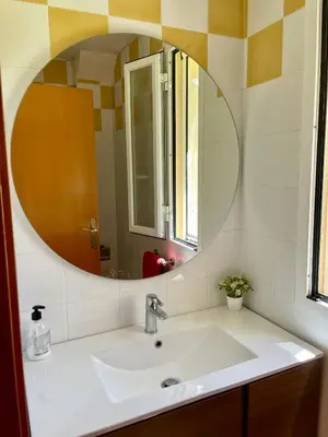 a bathroom with a sink and a mirror at Agradable adosado con piscina y jardín in Canet de Berenguer