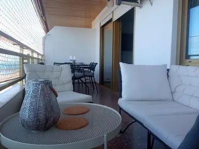 a living room with a couch and a table at Cullera Buena Vista Social Club con piscina y vistas al mar Solo Familias! in Cullera