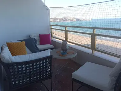a room with a balcony with a couch and a table at Cullera Buena Vista Social Club con piscina y vistas al mar Solo Familias! in Cullera