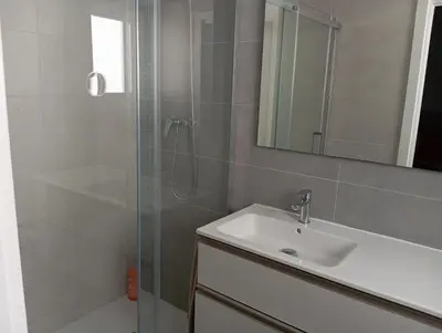 a bathroom with a sink and a shower with a mirror at Bellaterra, BQ-2, BAJO A in Cullera
