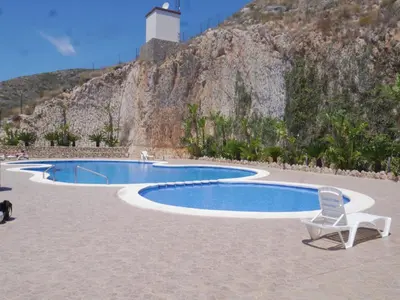 a chair sitting next to a swimming pool at Bellaterra, BQ-2, BAJO A in Cullera