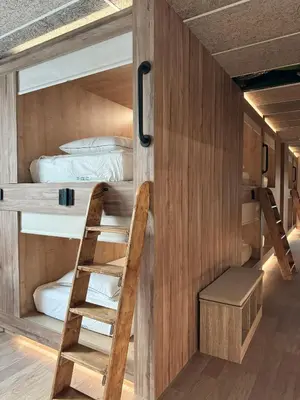 a room with two bunk beds and a ladder at The POD Suite Hostel Village in Valencia