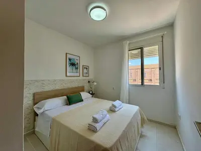 a bedroom with a bed with towels on it at Vistas al Castell de Alacuas in Alaquas