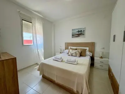 a bedroom with a bed with two towels on it at Vistas al Castell de Alacuas in Alaquas