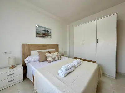 a bedroom with two beds with towels on them at Vistas al Castell de Alacuas in Alaquas