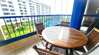 a wooden table and chairs on a balcony with a view at BEACH VALENCIA LUXURY D15-9 Apartment with terrace and sea views with two rooms in Valencia