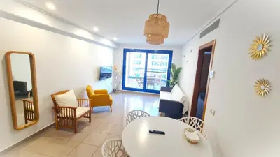 a living room with a white table and chairs at BEACH VALENCIA LUXURY D15-9 Apartment with terrace and sea views with two rooms in Valencia