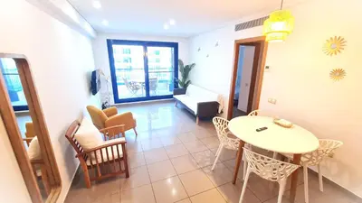 a living room with a table and chairs at BEACH VALENCIA LUXURY D15-9 Apartment with terrace and sea views with two rooms in Valencia