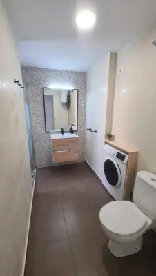 a bathroom with a toilet and a sink and a mirror at Vista Mar Apartamento Playa Farnals in Playa Pobla de Farnals