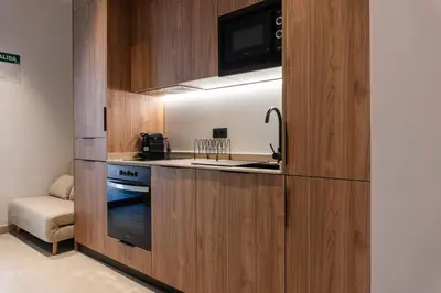 a small kitchen with a stove and a microwave at VLC HOST - Zapadores in Valencia