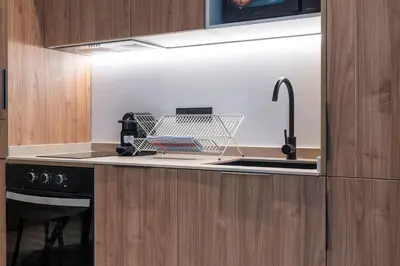a kitchen with a dish drying rack on a sink at VLC HOST - Zapadores in Valencia